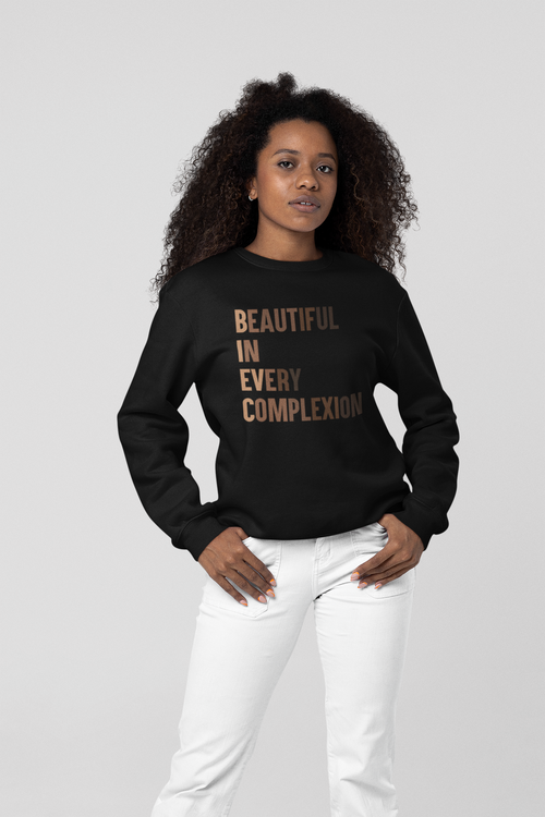 A Beautiful girl wearing high-quality 100% combed ring-spun cotton black sweatshirt with phrase " BEAUTIFUL IN EVERY COMPLEXION" and a white plain trouser.